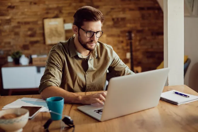 man deleting a comment on Instagram using a laptop