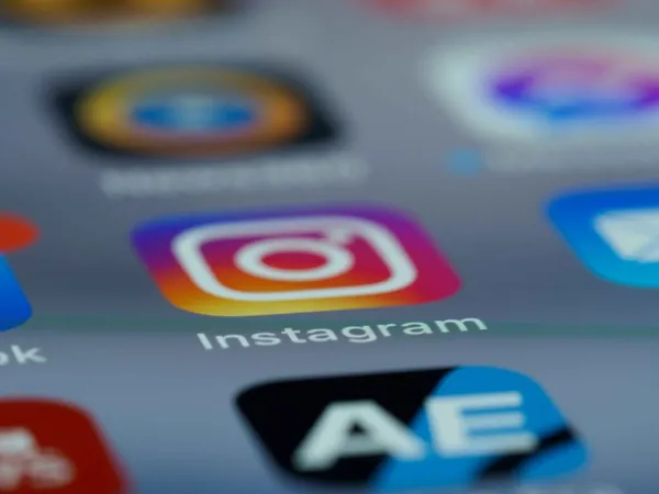 A smartphone screen displays the Instagram logo
