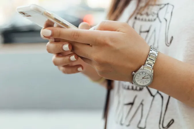 A young woman holding a phone.